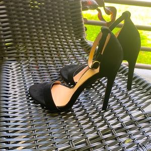 Black and gold 3 in heels with a leather type material